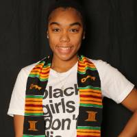 student smiling for a picture at GradFest photobooth